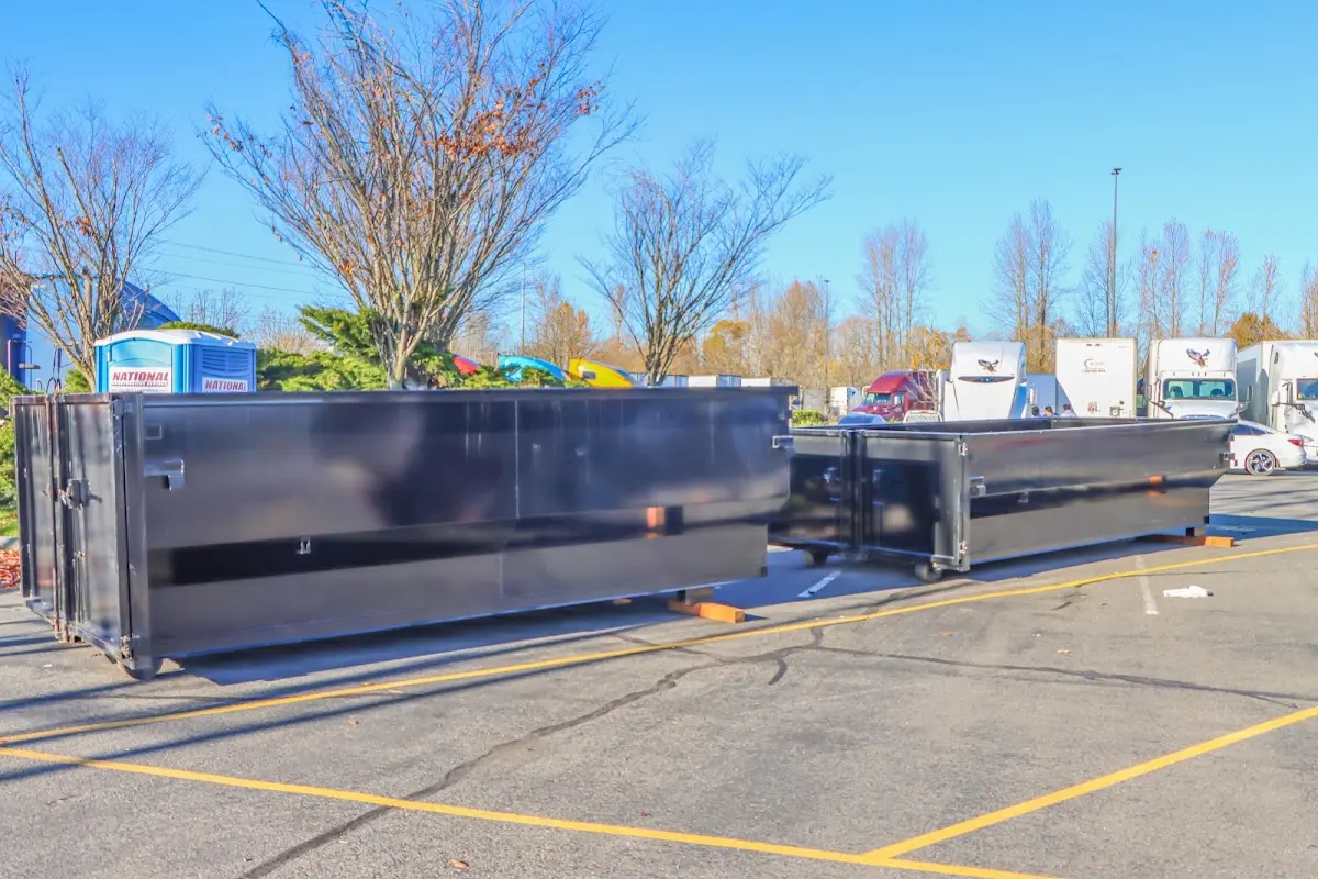 Professional dumpster rental service with roll-off container on residential driveway in Peppermill Village